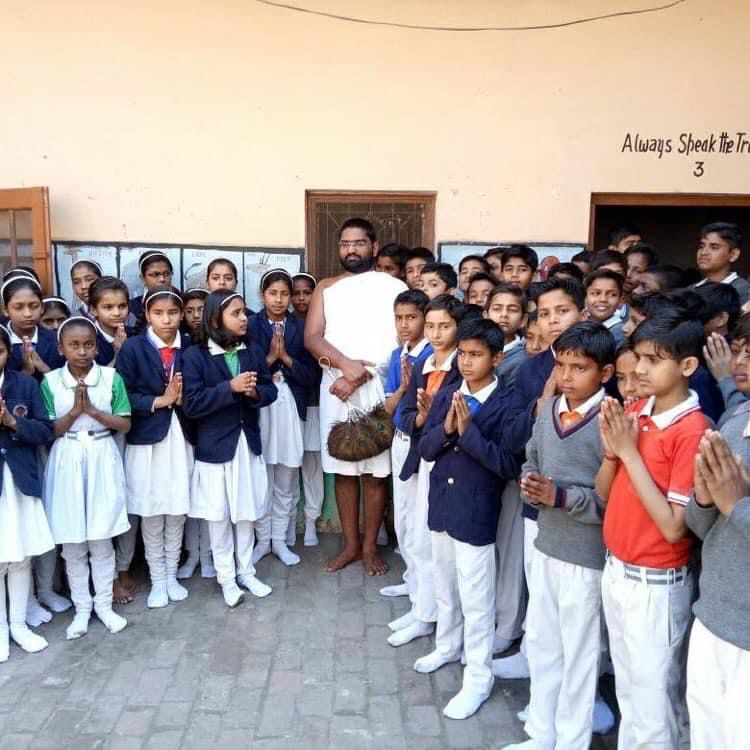 At school with students — Maharaj Ji surrounded by uniformed schoolchildren