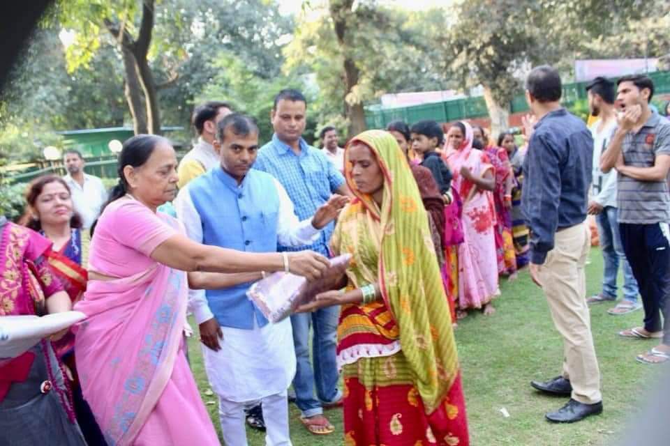 Community saree distribution drive organised by Dharmyog Foundation — Maharaj Ji's volunteers handing essentials to women