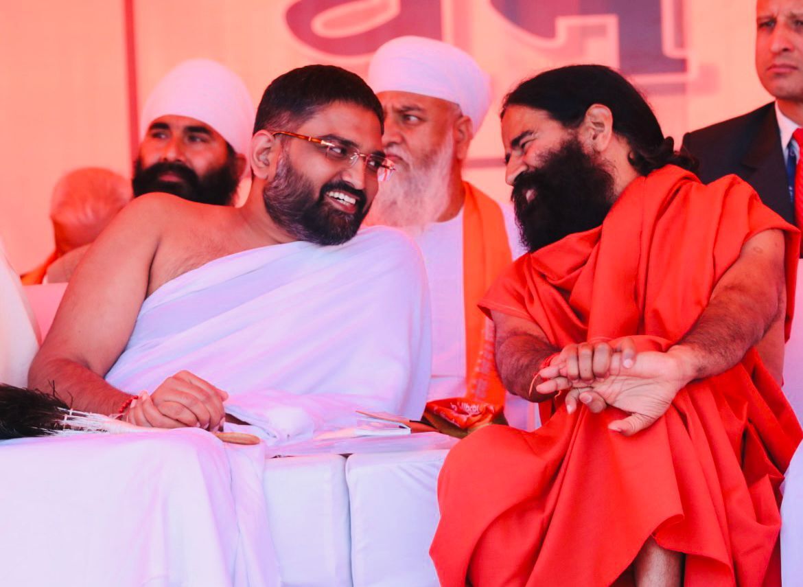 Yog Bhooshan Maharaj sharing a candid moment with Yogrishi Swami Ramdev